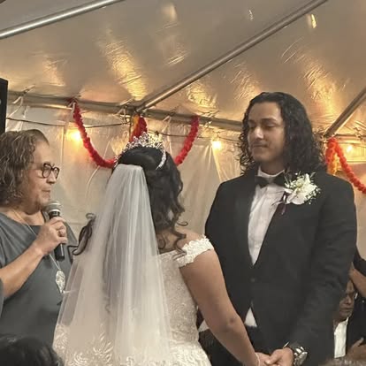 Esther officiating a ceremony under a decorated tent
