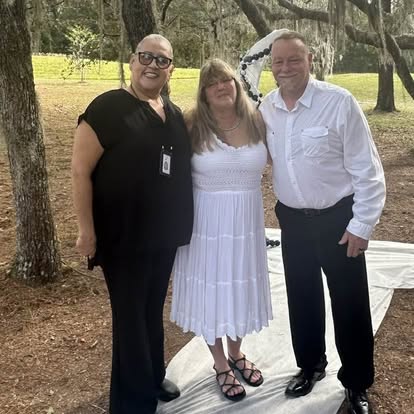 Esther with a couple beside a lake