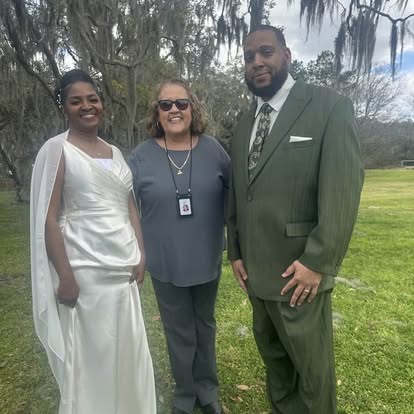 Esther with a bride and groom outdoors