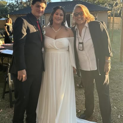 Esther with a newly married couple at sunset