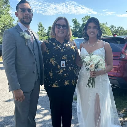 Esther standing with a couple outdoors
