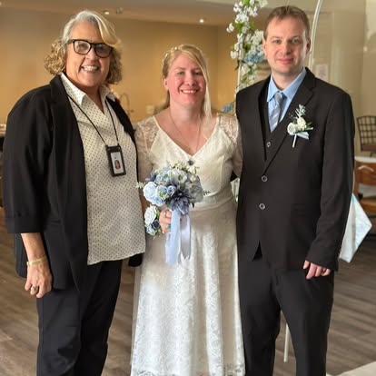 Esther with newlyweds inside a decorated room
