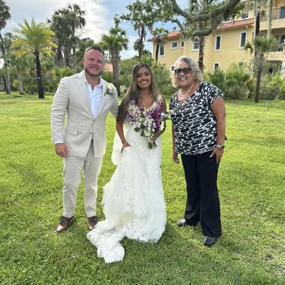 Esther with newlyweds in a garden courtyard