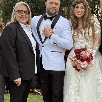 Esther with newlyweds and a burgundy bridal bouquet