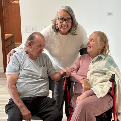 Esther with a couple at an intimate indoor ceremony