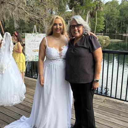 Esther with a bride beside a waterfront railing
