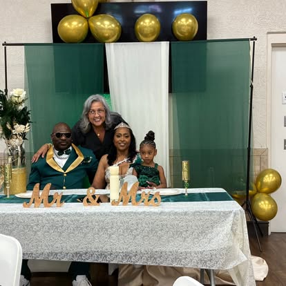 Wedding party gathered at a decorated reception table