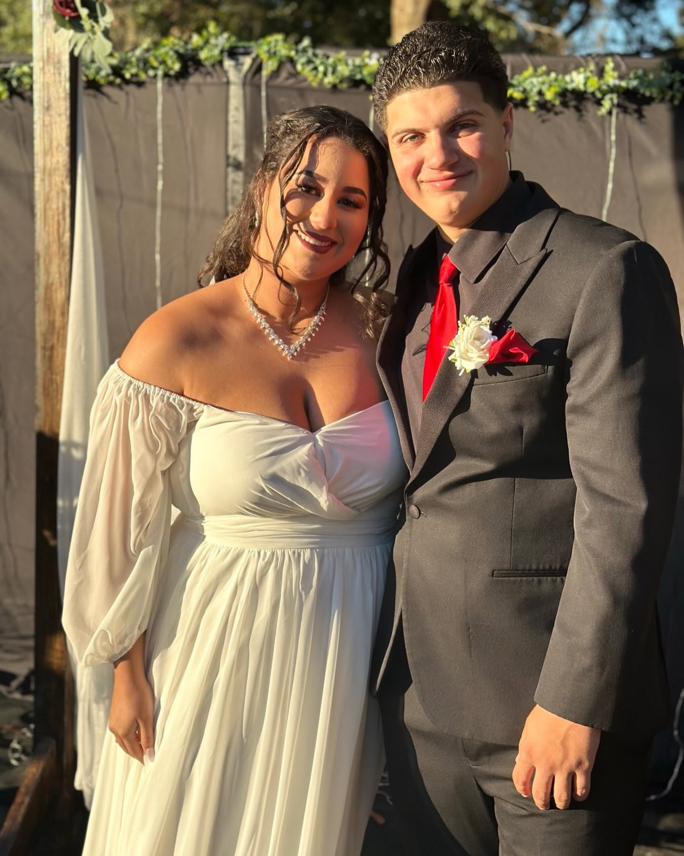 Newlyweds smiling together outdoors