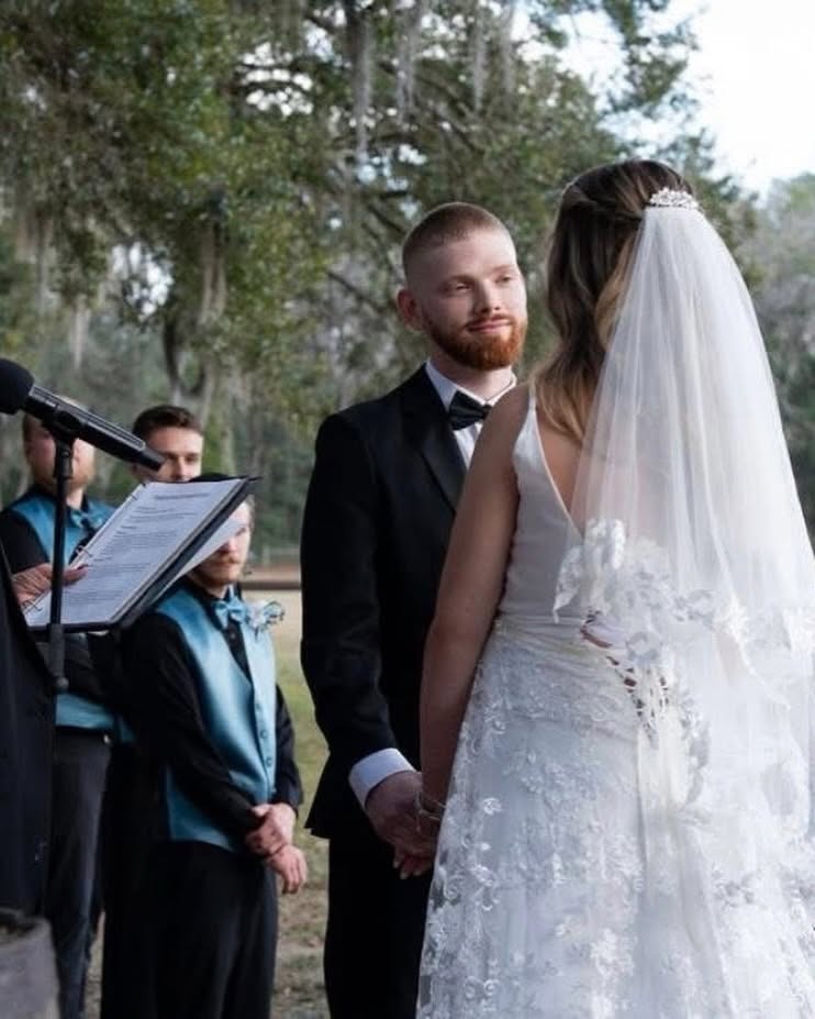 A bride and groom exchanging outdoor vows